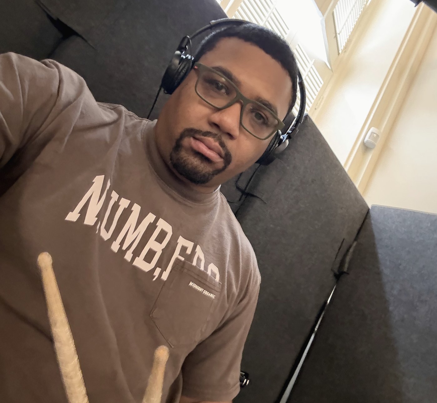 Dante Harris, sticks and headphones, close frame